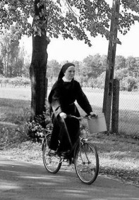 nun on bicycle